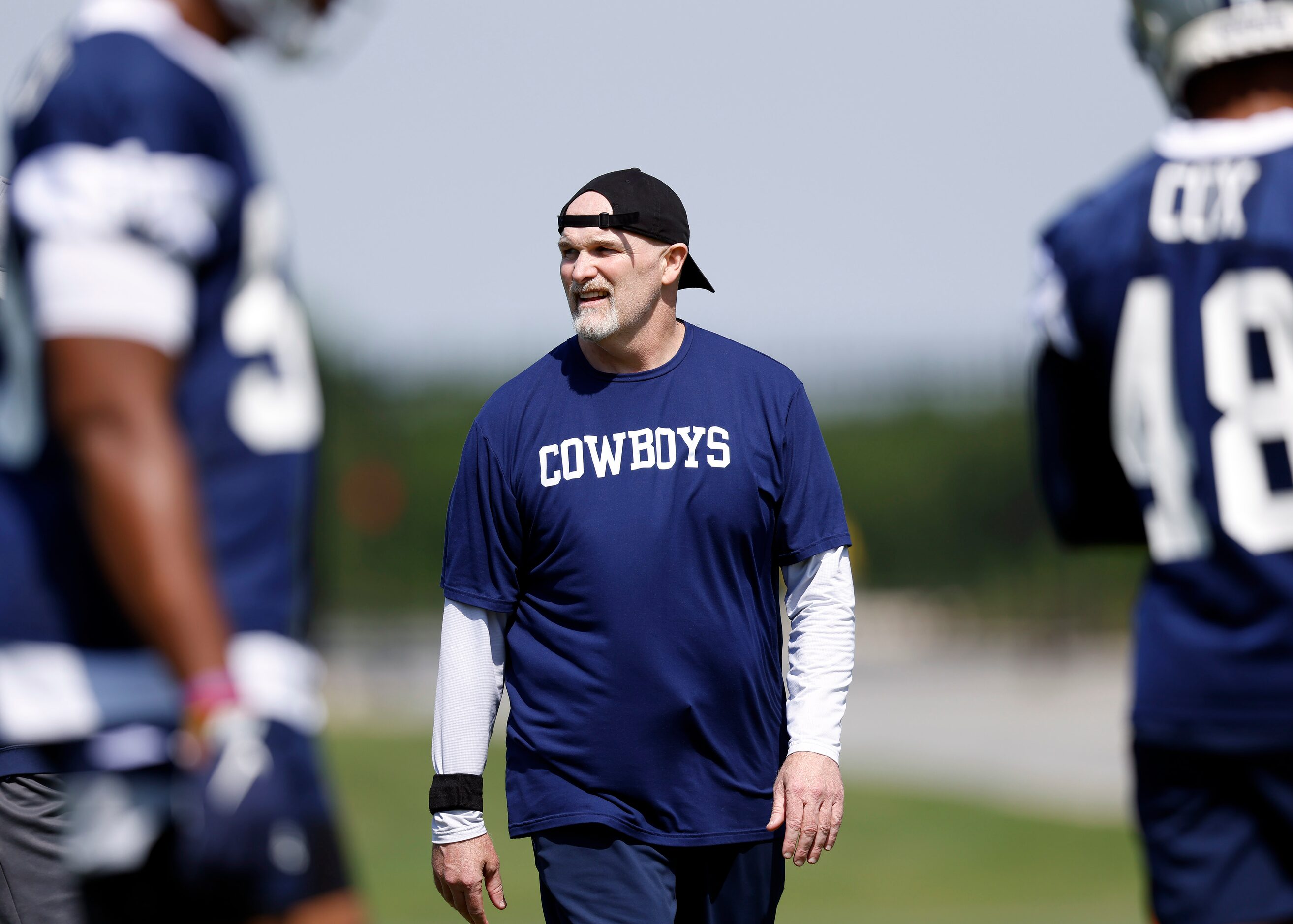 Dallas Cowboys defensive coordinator Dan Quinn watches his players during rookie minicamp at...