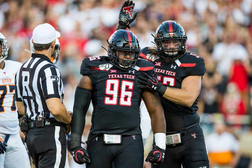 LUBBOCK, TEXAS - SEPTEMBER 07: Defensive lineman Broderick Washington Jr. #96 and defensive...