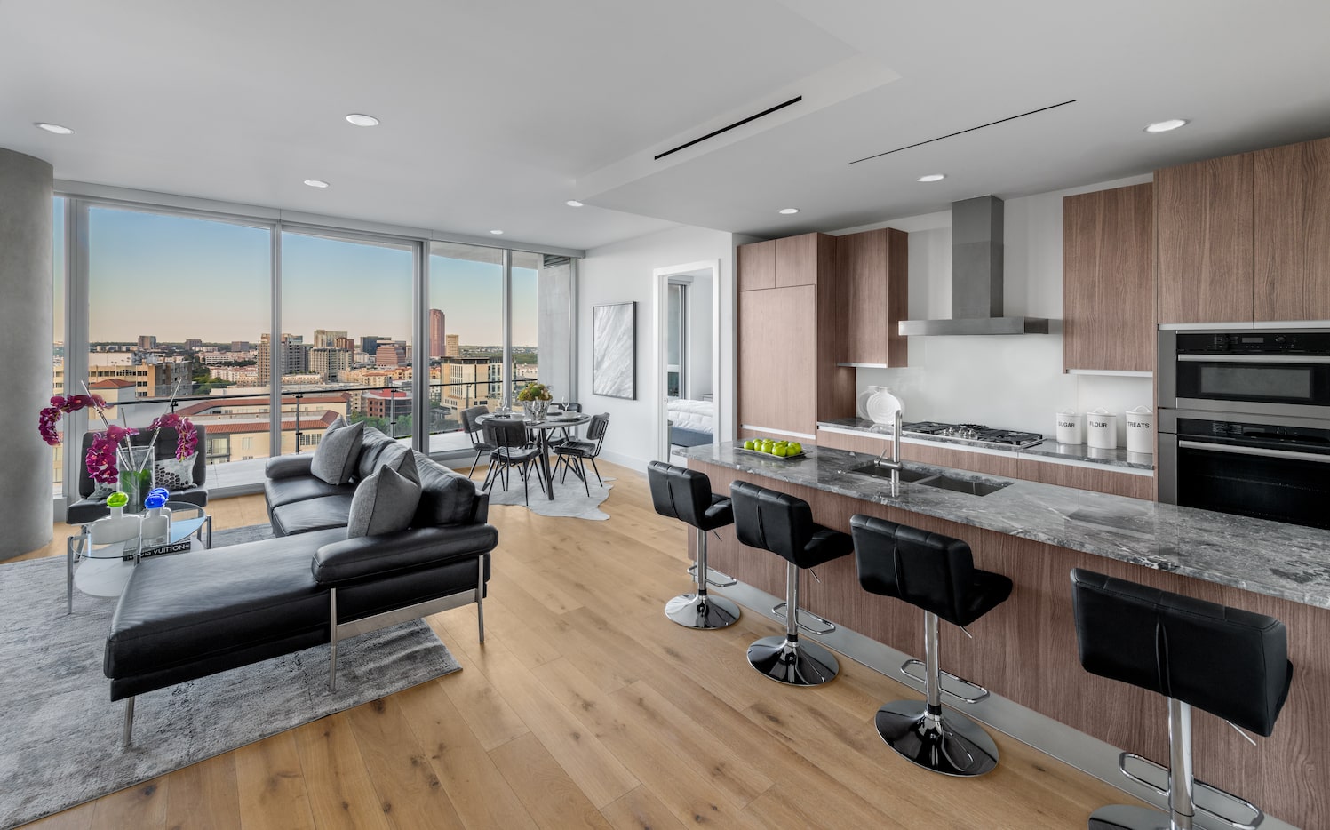 The kitchen, living area, and dining room look out to the city.