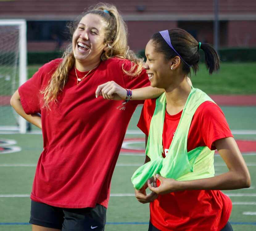 
Coppell Cowgirls teammates Emma Jett (left) and Mackenzie McFarland laugh together during...