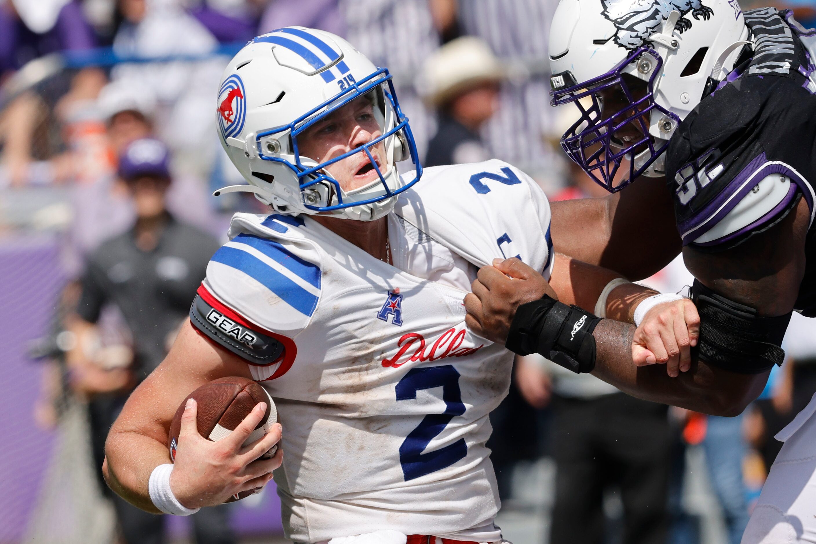 Southern Methodist Mustangs quarterback Preston Stone (2) is sacked by TCU Horned Frogs...