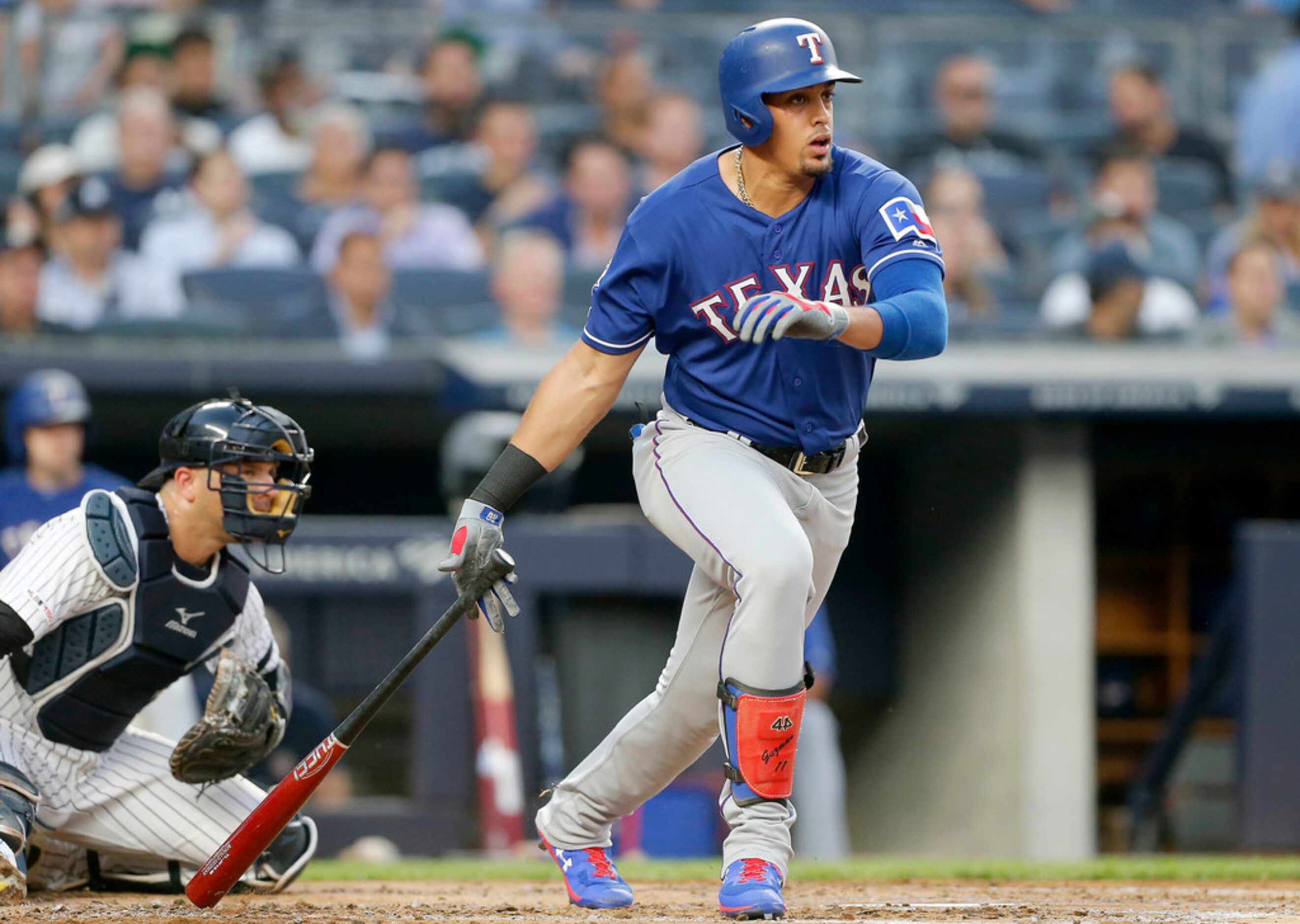 NEW YORK, NEW YORK - SEPTEMBER 04:   Ronald Guzman #11 of the Texas Rangers follows through...