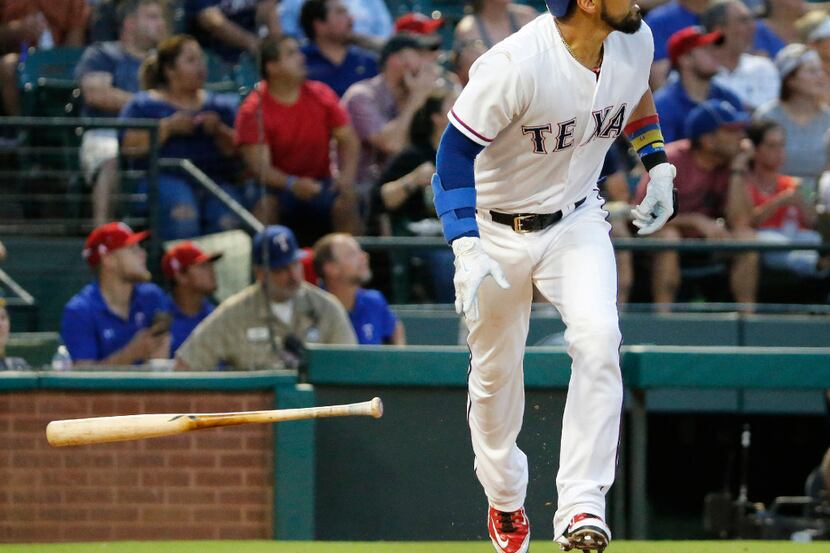 Texas Rangers catcher Robinson Chirinos (61) watches the flight of his third-inning homer...