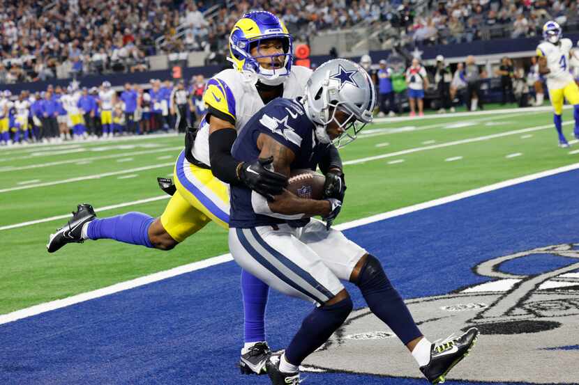 Dallas Cowboys wide receiver Brandin Cooks (3), right, catches a pass under pressure from...