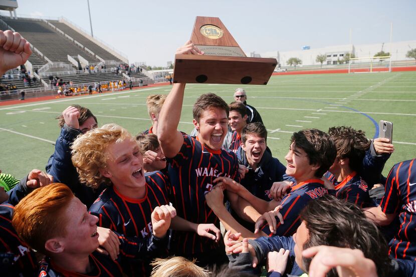 Frisco Wakeland's Matt Muzar (23) holds the regional trophy after defeating Mount Pleasant...