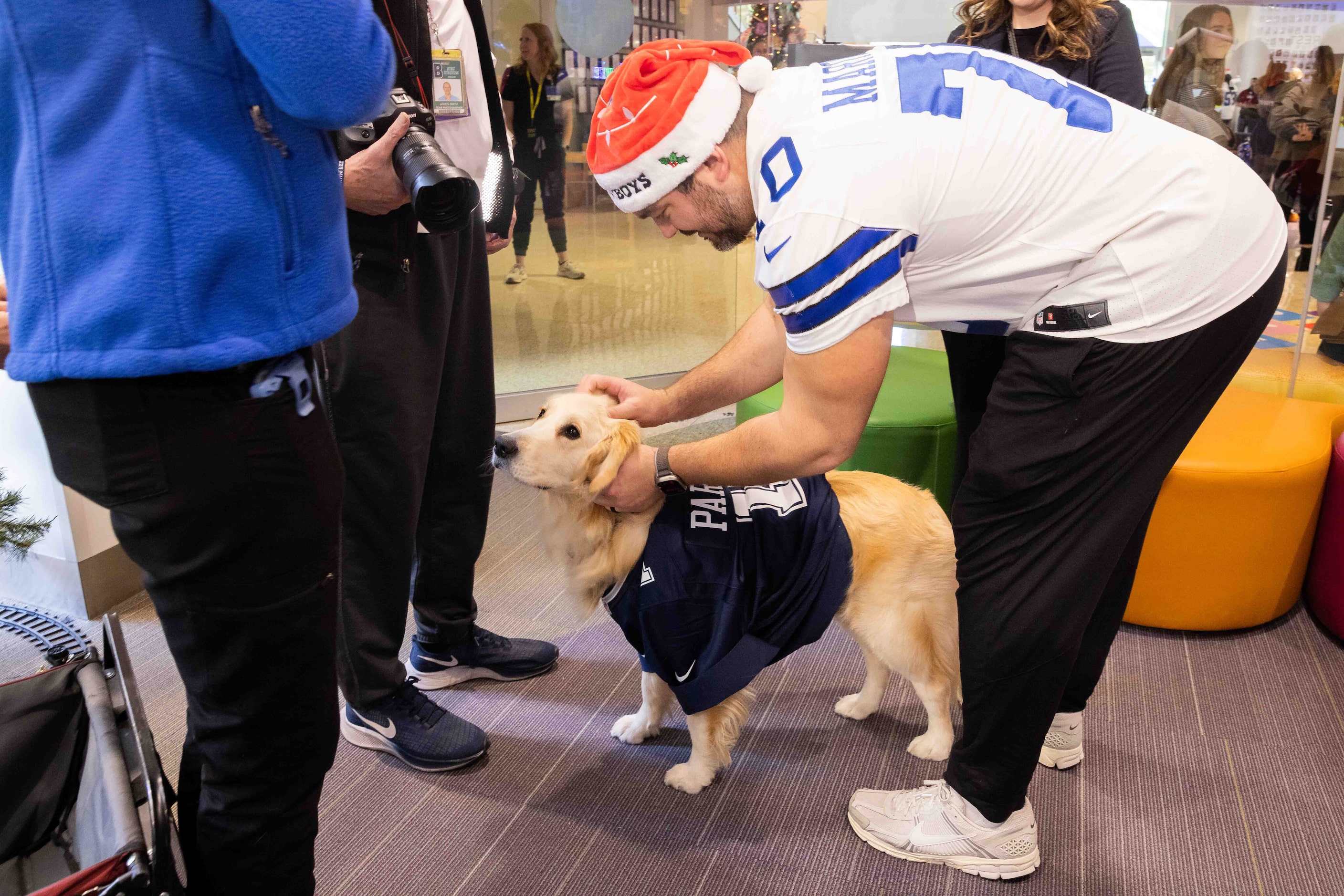 Dallas Cowboys guard Zack Martin (70) pets hospital facility dog Maze at Seacrest Studios in...