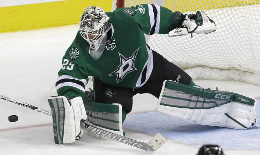 Dallas Stars goalie Anders Lindback (29) blocks a shot during the second period of an NHL...