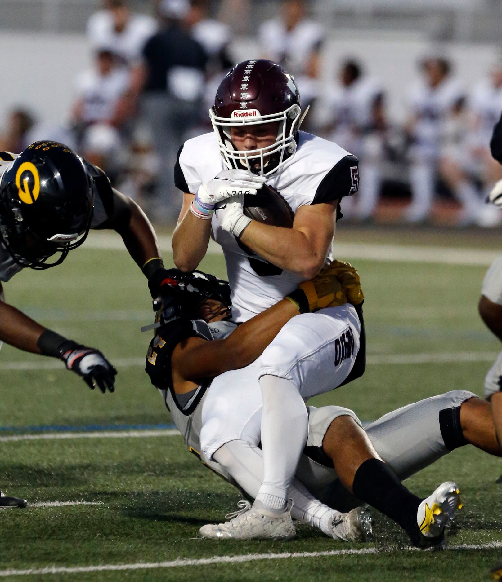 Wylie high’s Blake Fuller (5) is stopped by Garland defender Jeremy Carcamo (24) during the...
