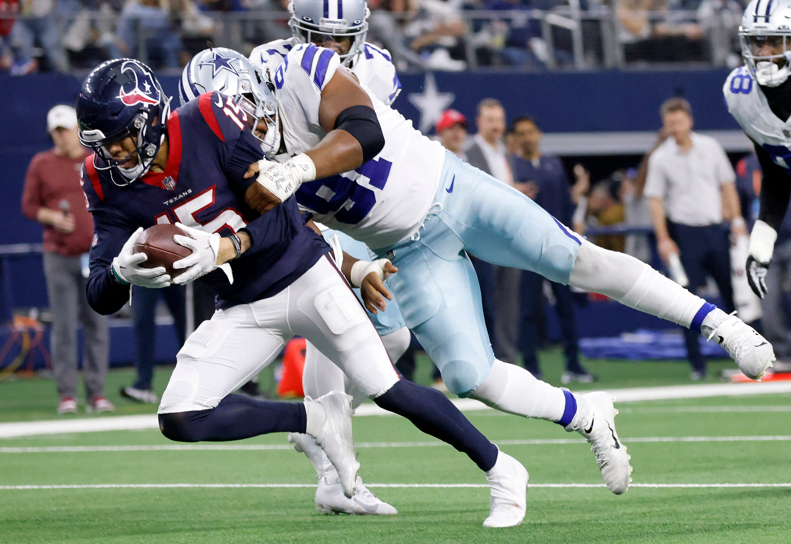 Dallas Cowboys defensive end Carlos Watkins (91) tackles Houston Texans wide receiver Chris...