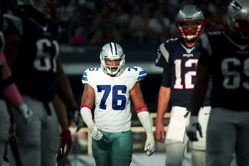 Dallas Cowboys defensive end Greg Hardy (76) eyes New England Patriots quarterback Tom Brady...