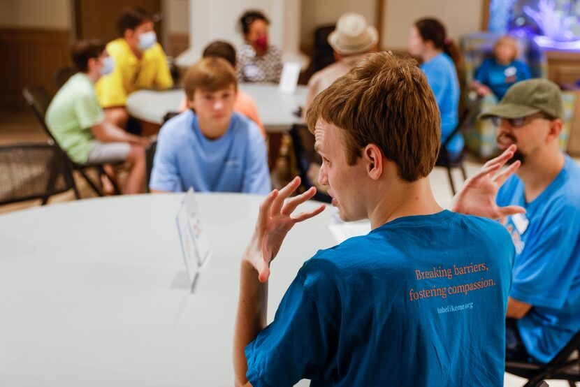 Event leader Jacob Kunko interacts with participants in a coffee shop scenario during a...