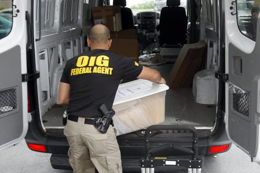 A federal agent load seized boxes from a Miami home health agency in 2012 as authorities...
