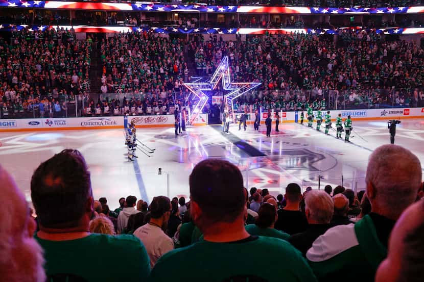 Fans stand for the national anthem before the season opener between the Dallas Stars and the...