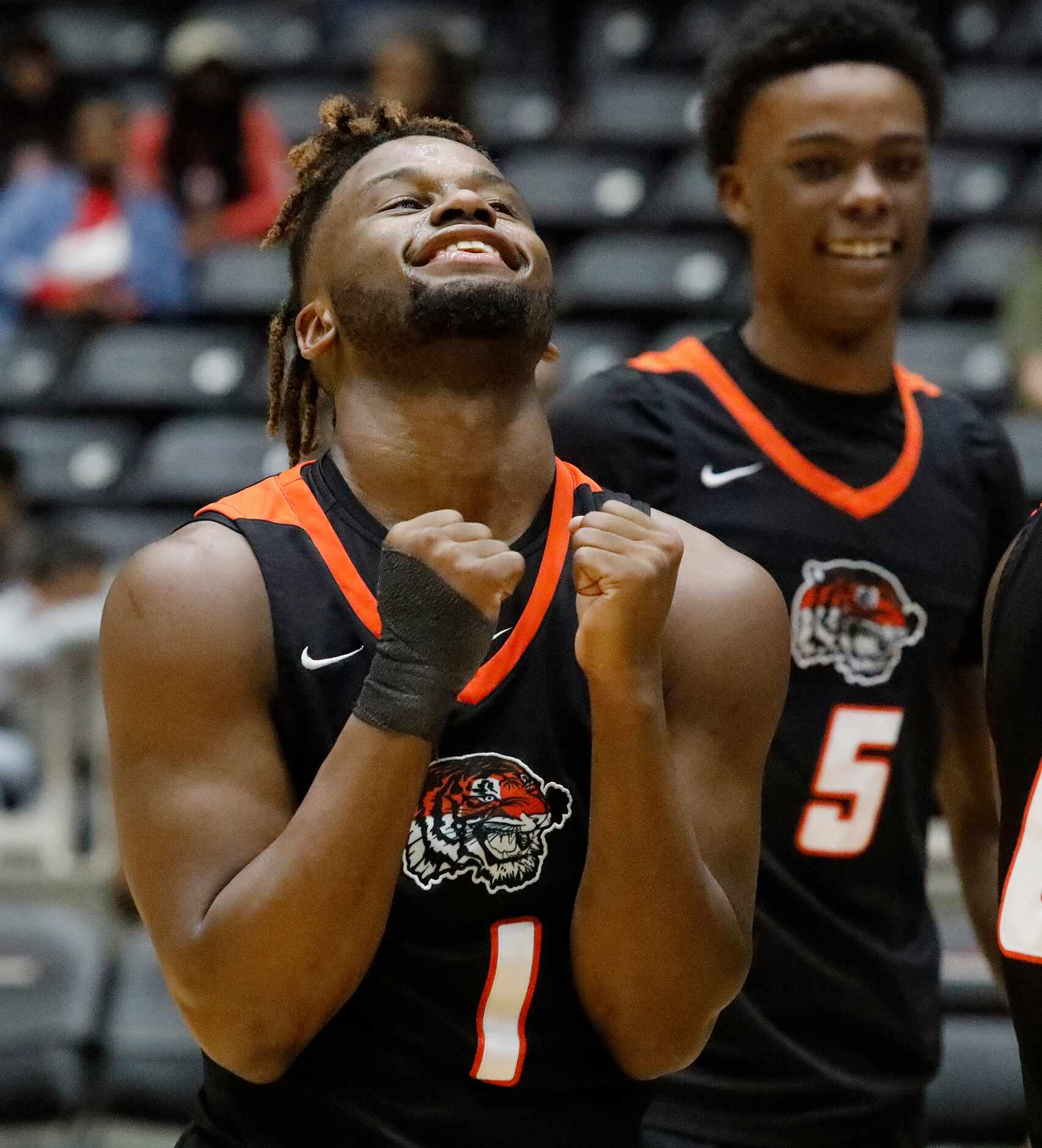 Lancaster High School guard Mike Miles (1) celebrates the moment as time expires with  a win...