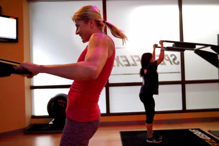 Tara Durham (left) and Jordan Siegel work out during a Speedflex class.