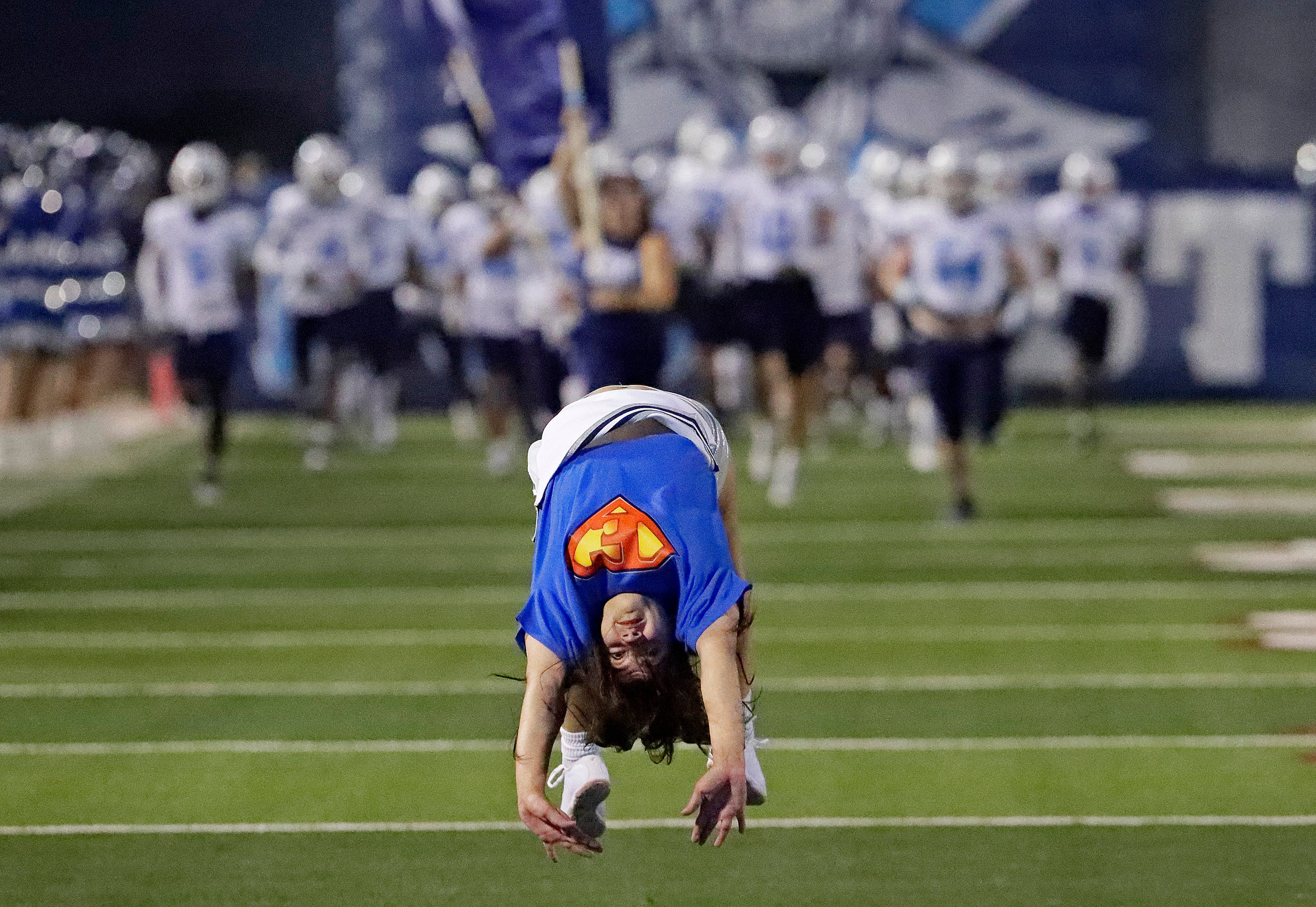 Wylie East High School cheerleader Mackenzie Zambrano, 17, does back flips as the football...