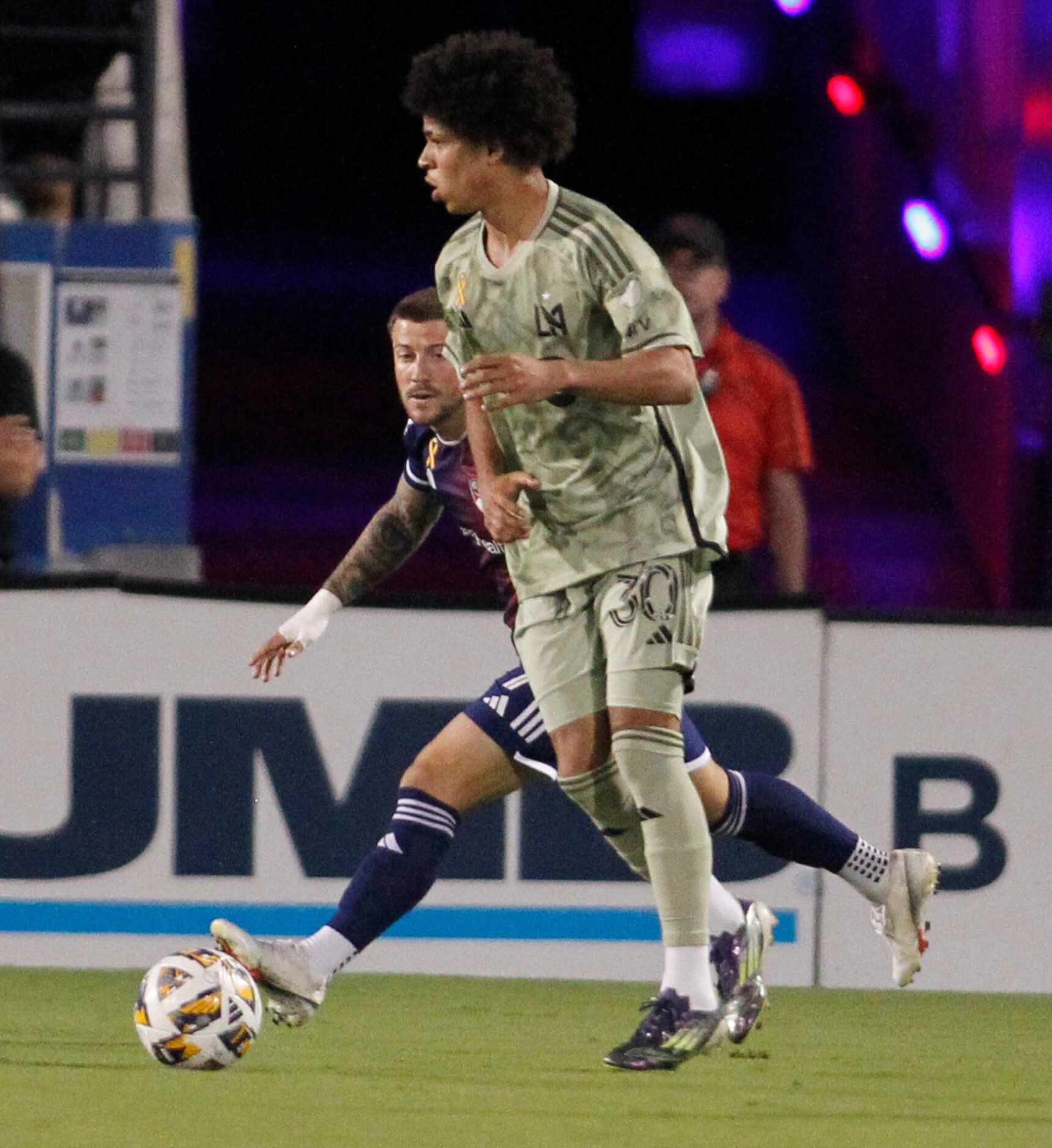 FC Dallas midfielder Paul Arriola (7), background, sneaks in behind LAFC attacker David...