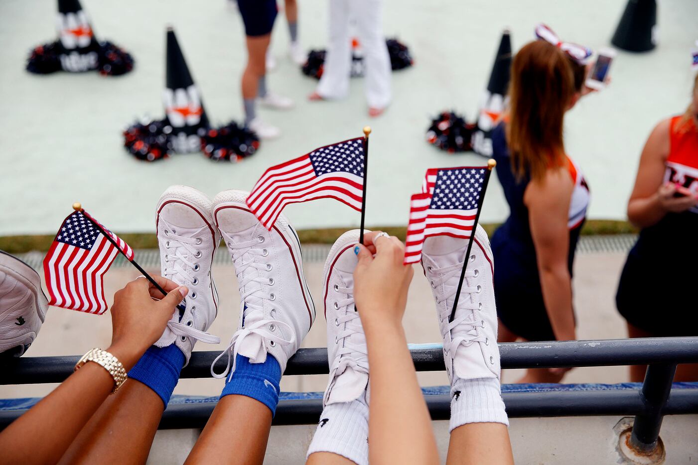 Frisco Wakeland fans place flags in their shoes before a football game between Wakeland and...