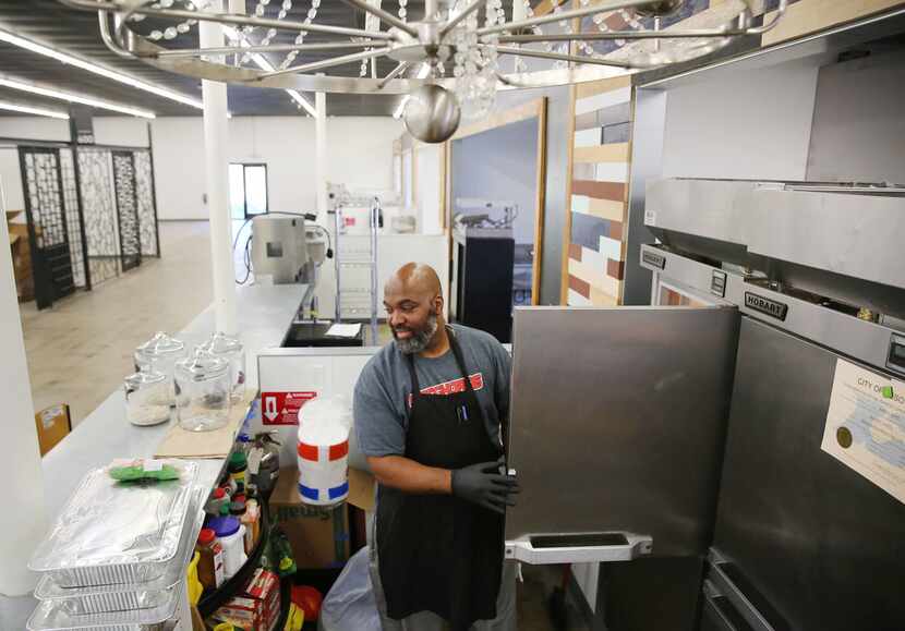 Chef Alex Goss, who teaches culinary arts at Cedar Hill High School, prepares meals for...