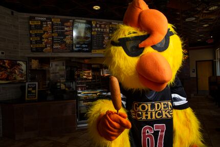 Clucky, Golden Chick's mascot, holds a Fletcher's corny dog at the fast-food restaurant at...