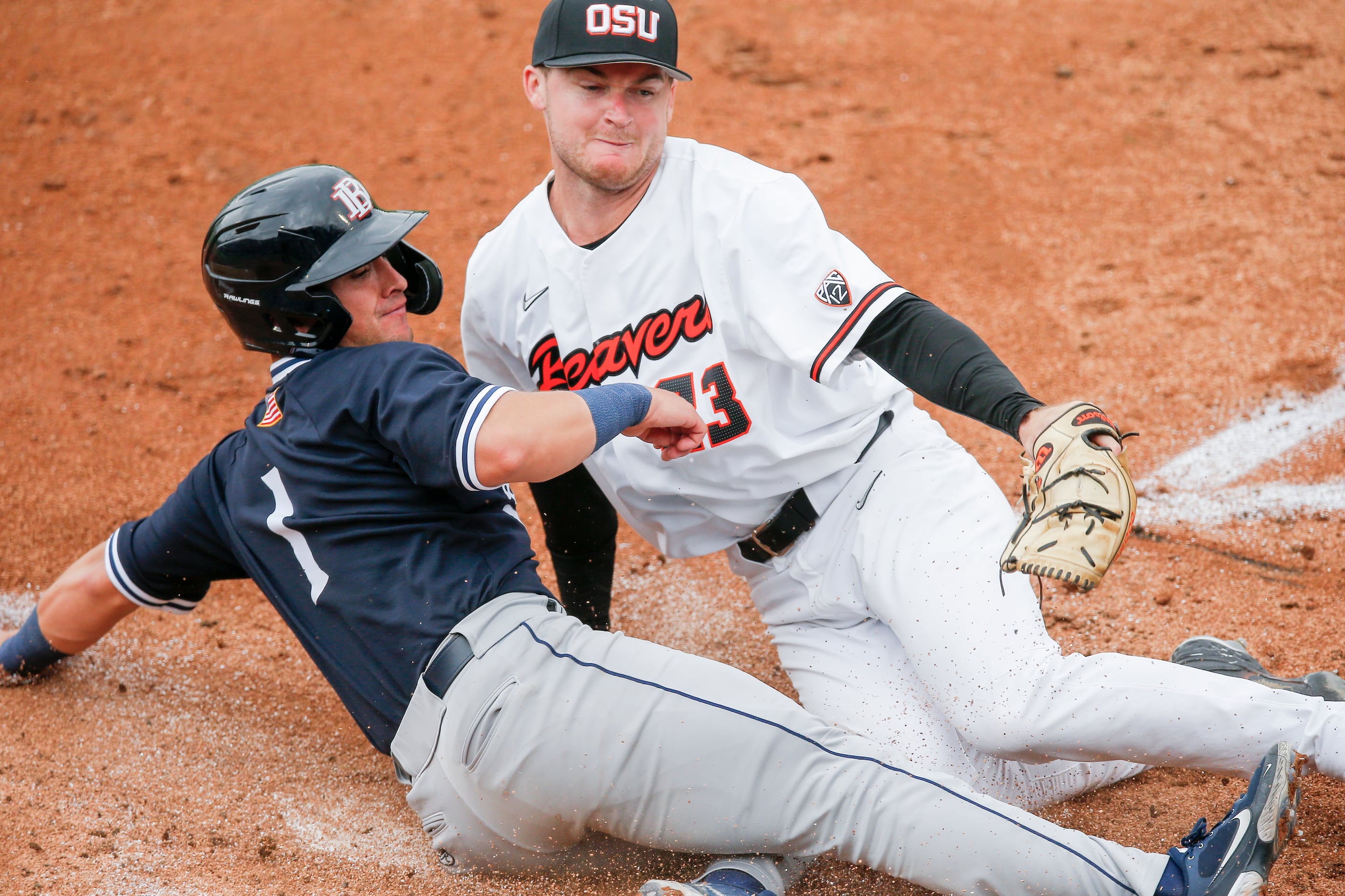 Oregon St. starting pitcher Kevin Abel (23) tags out DBU Andres Sosa (1) at home in the...