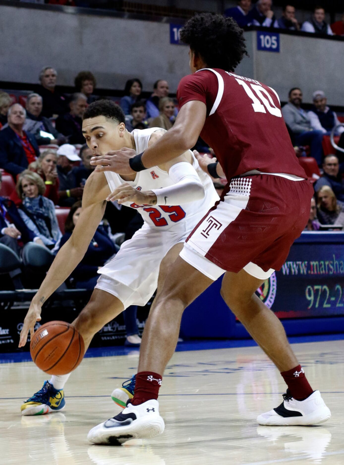 SMU forward Ethan Charges (25) drives against the defense of Temple forward Jake Forrester...