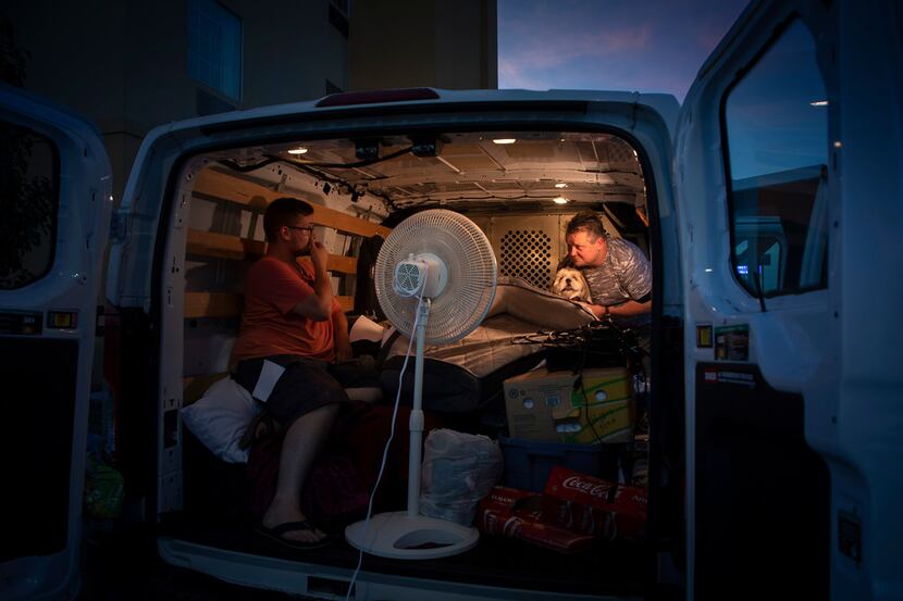 Jeff Slaughter (right) talks with his son, Cameron, in the back of a U-Haul van  Wednesday...