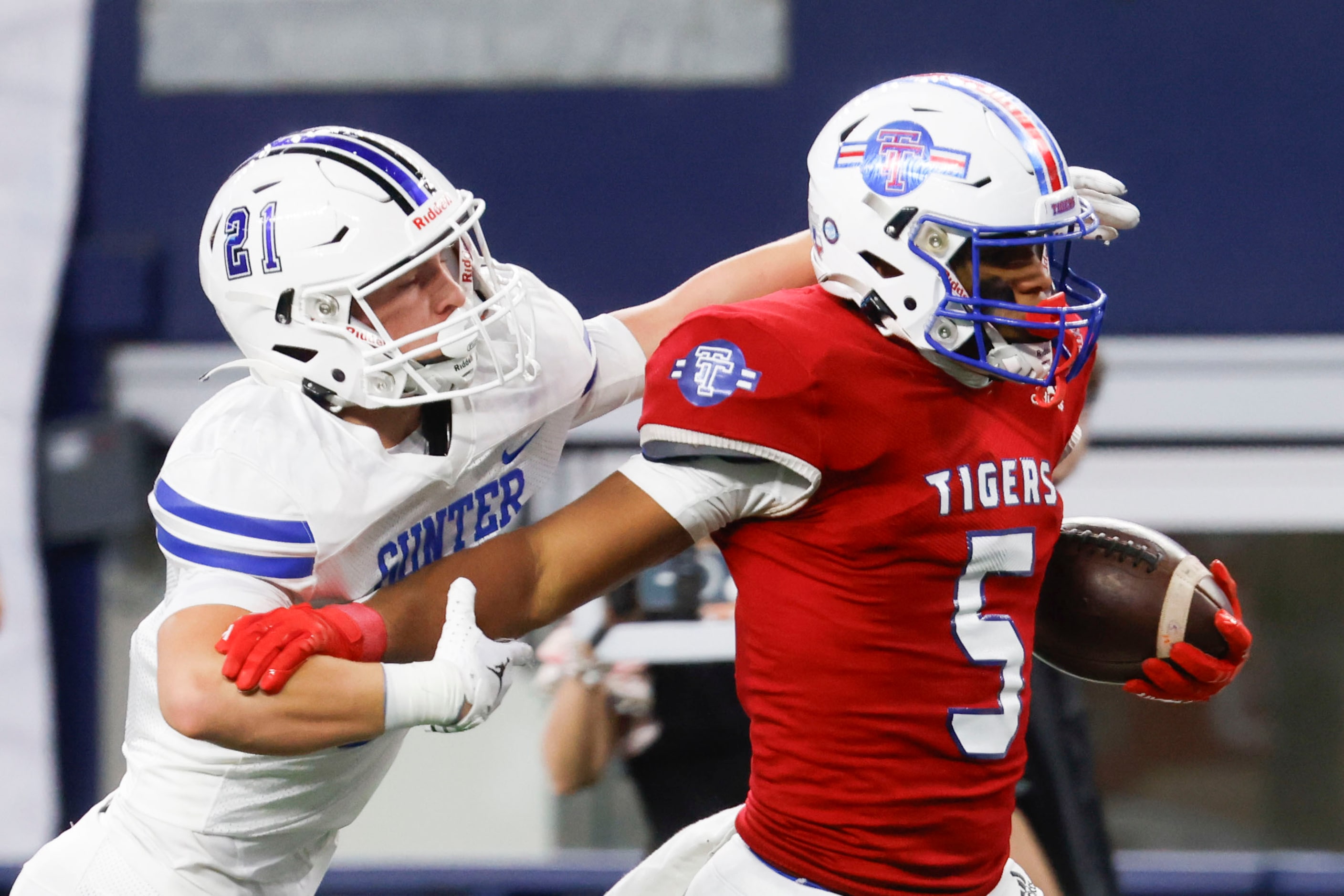 Gunter High’s Parker Harris (left) tackles El Maton Tidehaven’s Joseph Dodds as he gains a...