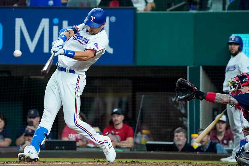 Texas Rangers first baseman Nate Lowe drives in run with a single during the third inning...