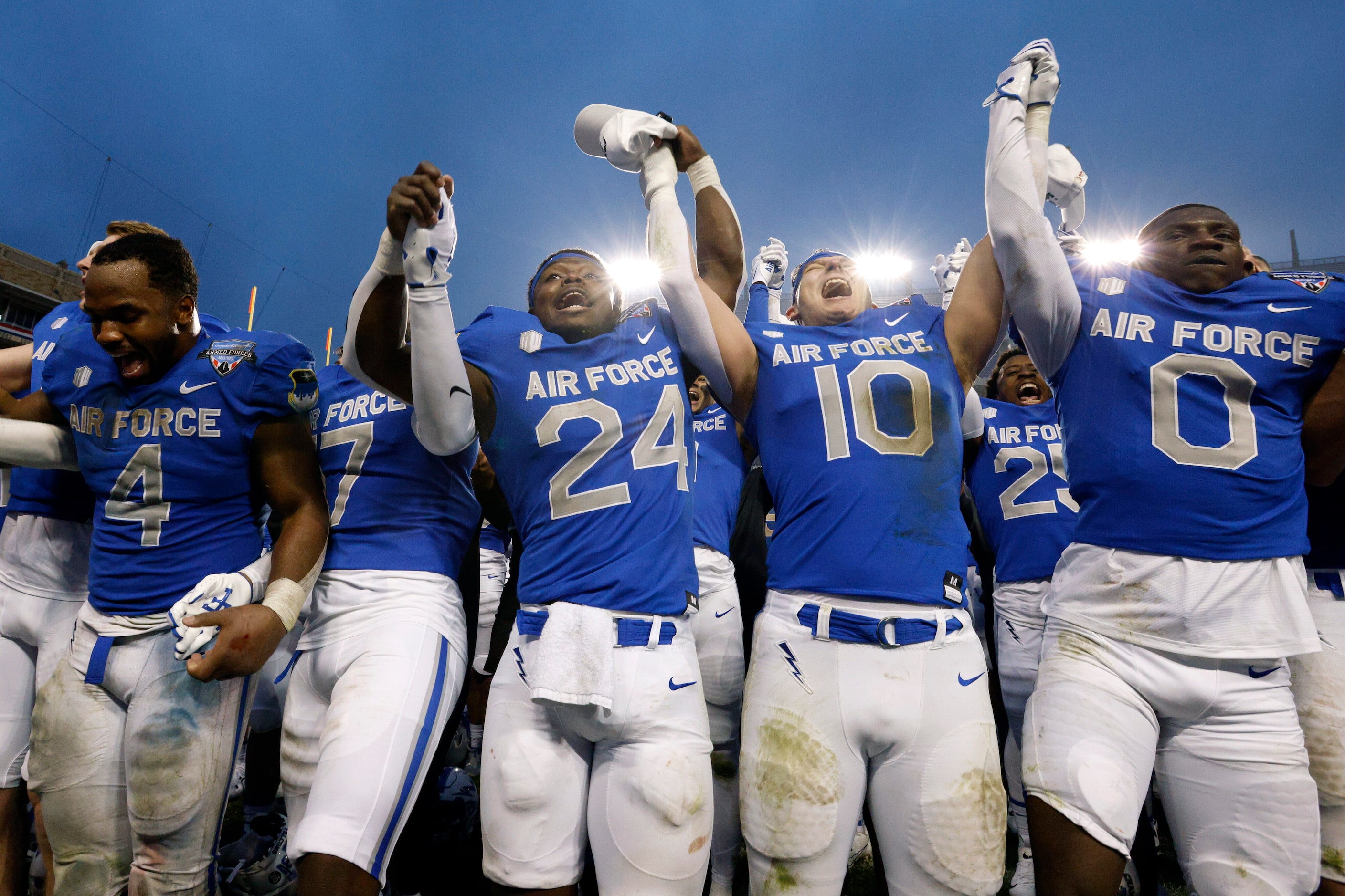 Air Force players sing the school song after winning the Armed Forces Bowl NCAA football...