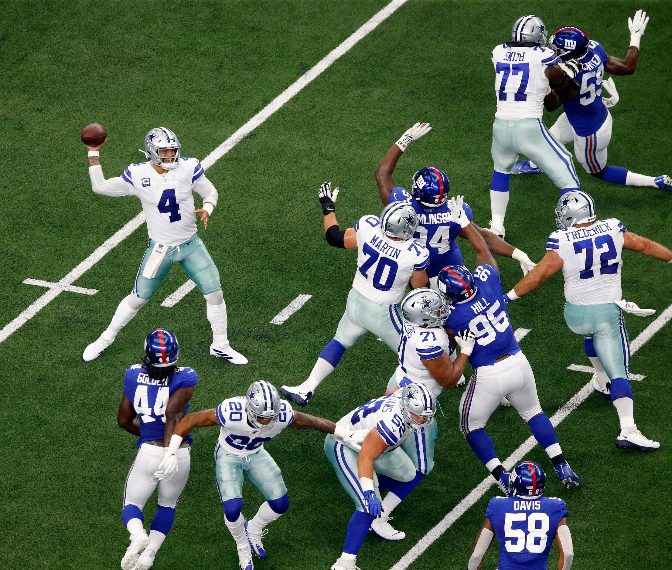 Dallas Cowboys quarterback Dak Prescott (4) gets time to throw with the help of his...