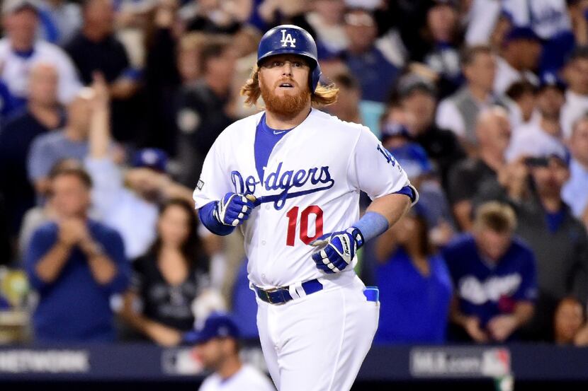 Justin Turner #10 of the Los Angeles Dodgers rounds the bases after he hits a solo home run...