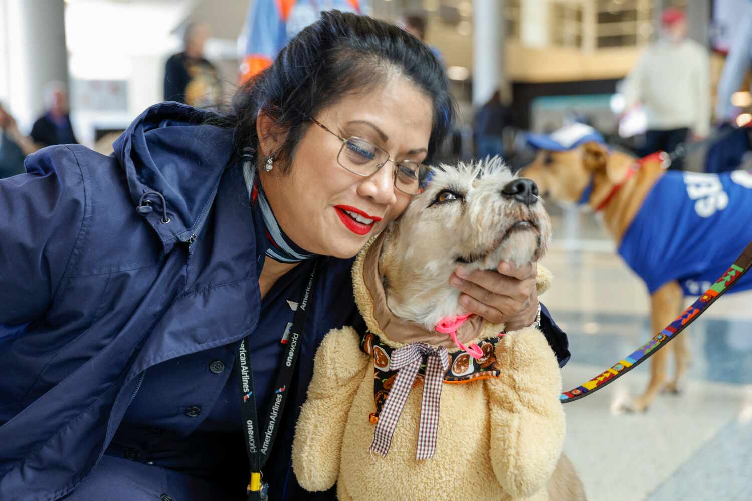 American Eagle flight attendant Carmel O. hugs Frankie an eight-year-old therapy dog at...