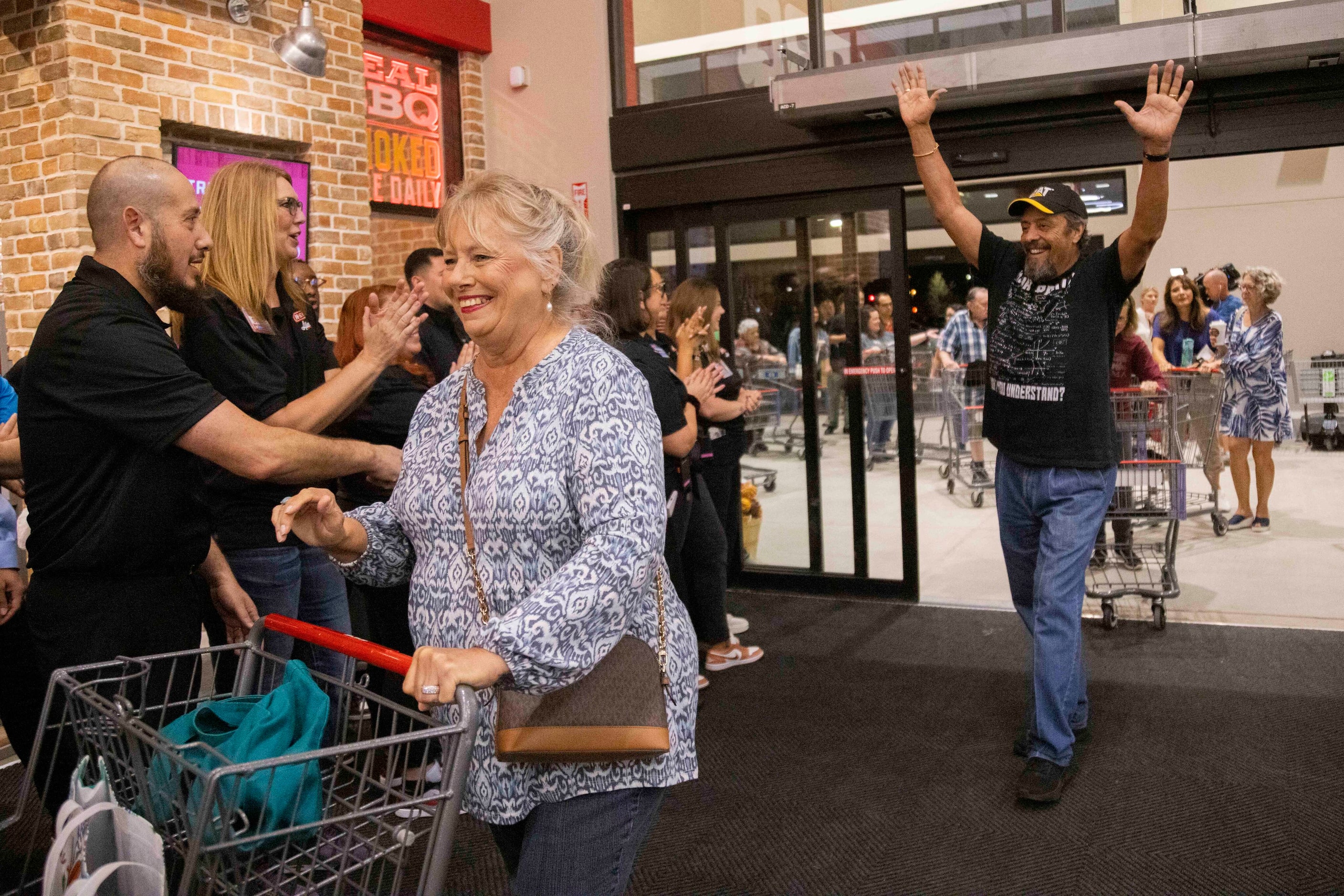 Customers Taffy Delgado (left) and Ruben Delgado of McKinney walk into the store during the...