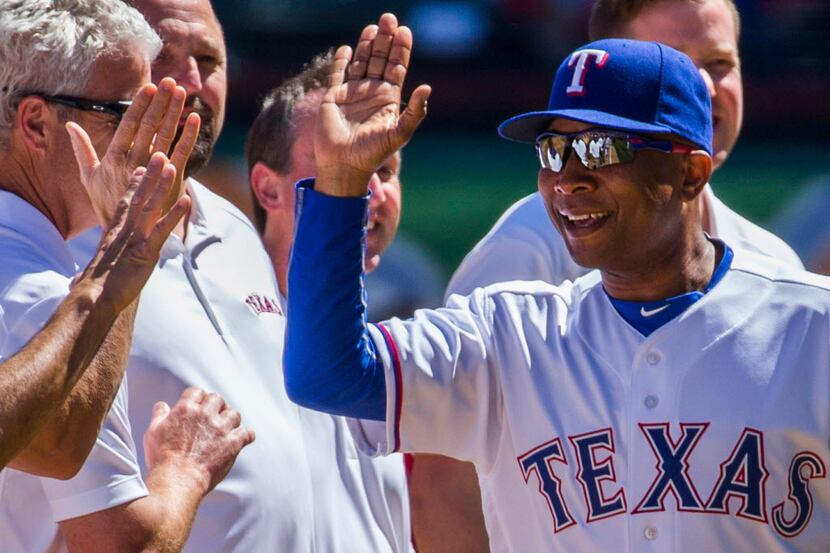 Texas Rangers third base coach Tony Beasley takes the field during pregame introductions...