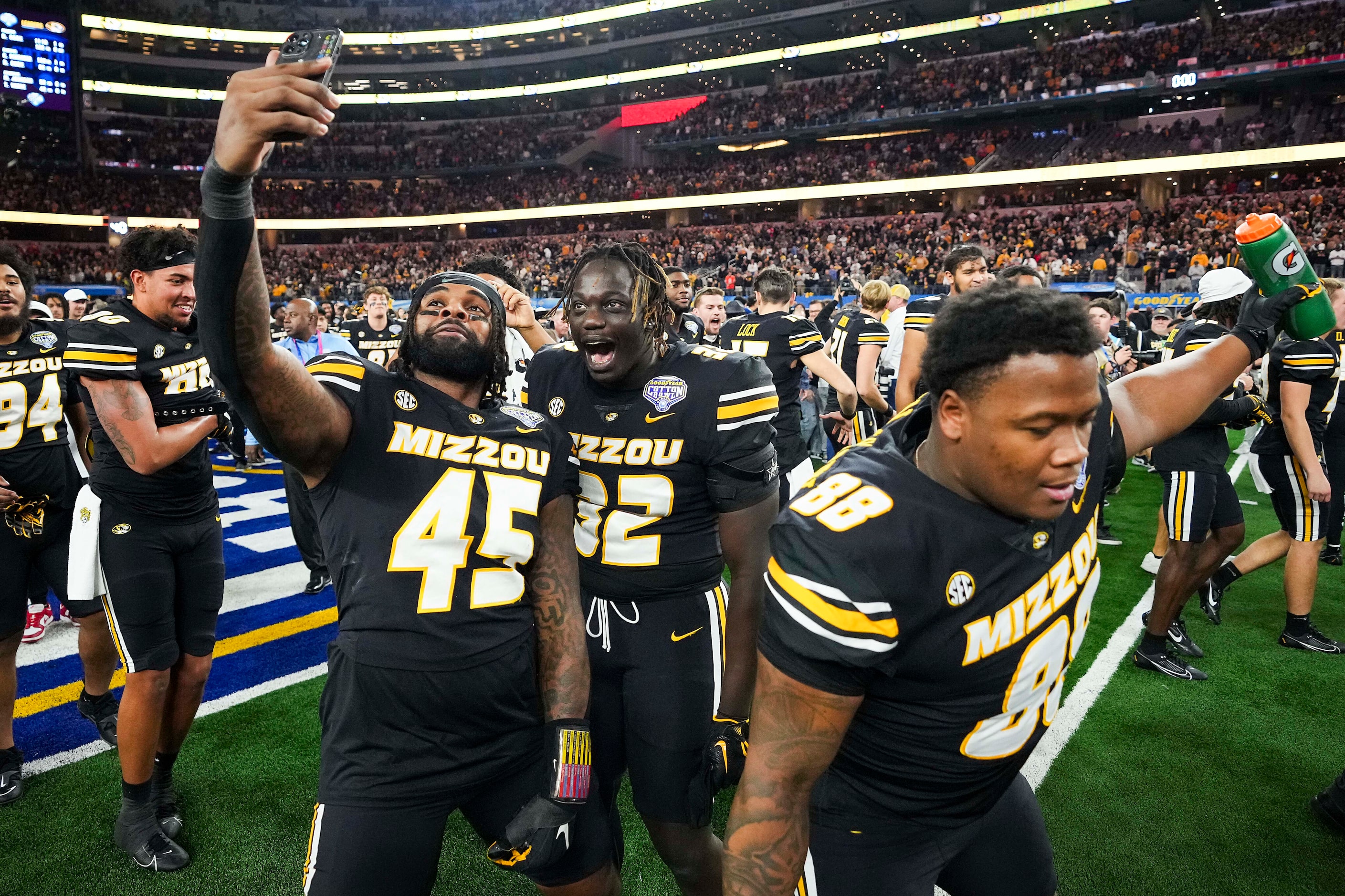 Missouri players, including defensive linemen Joe Moore (45) and Serigne Tounkara (32)...