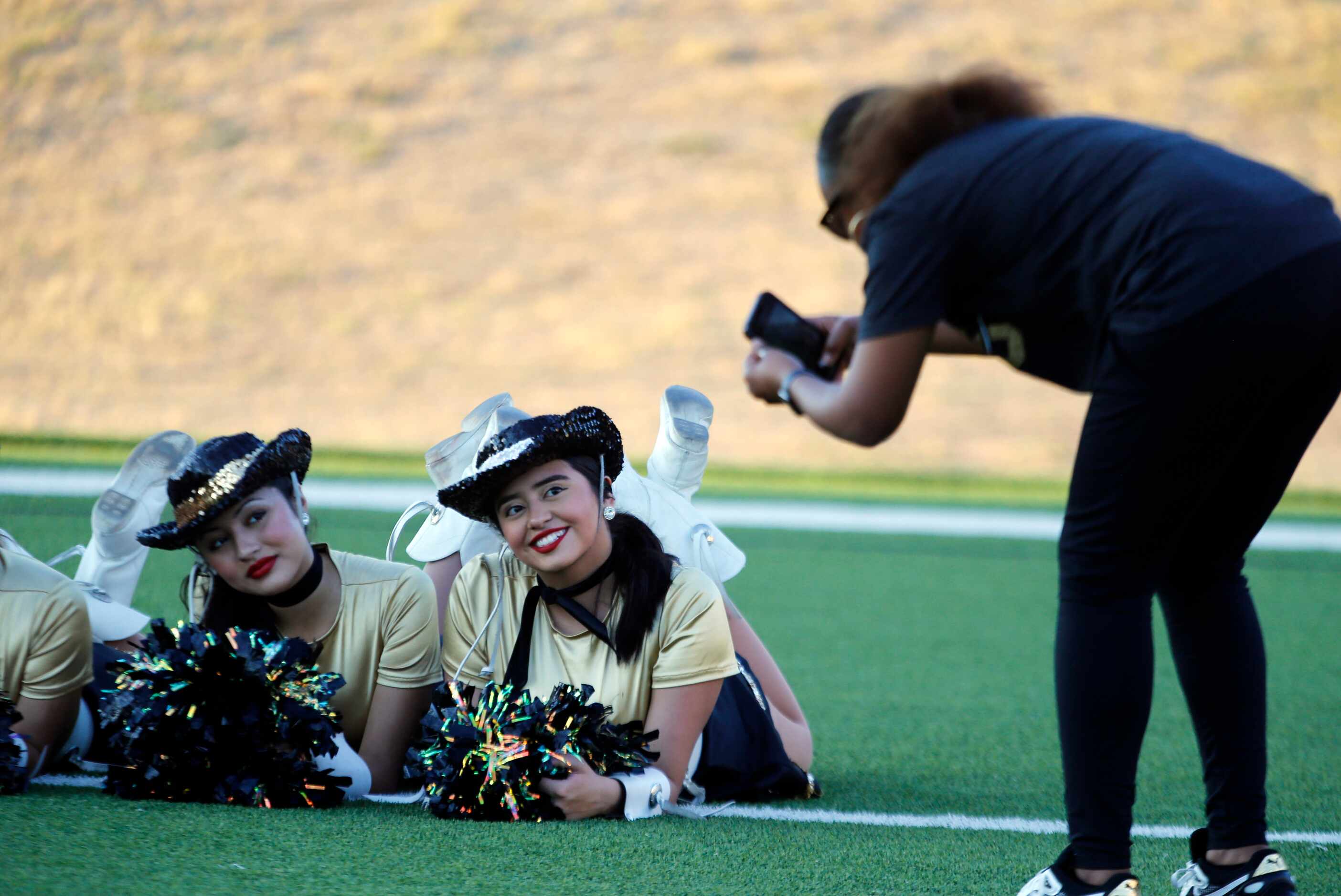 Irving high drill team members smile during some picture-taking before the start of the...