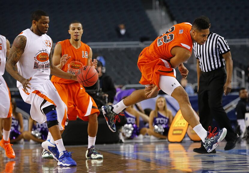 East forward Jerrelle Benimon (22) of Towson tries to pass the ball between his legs as he...