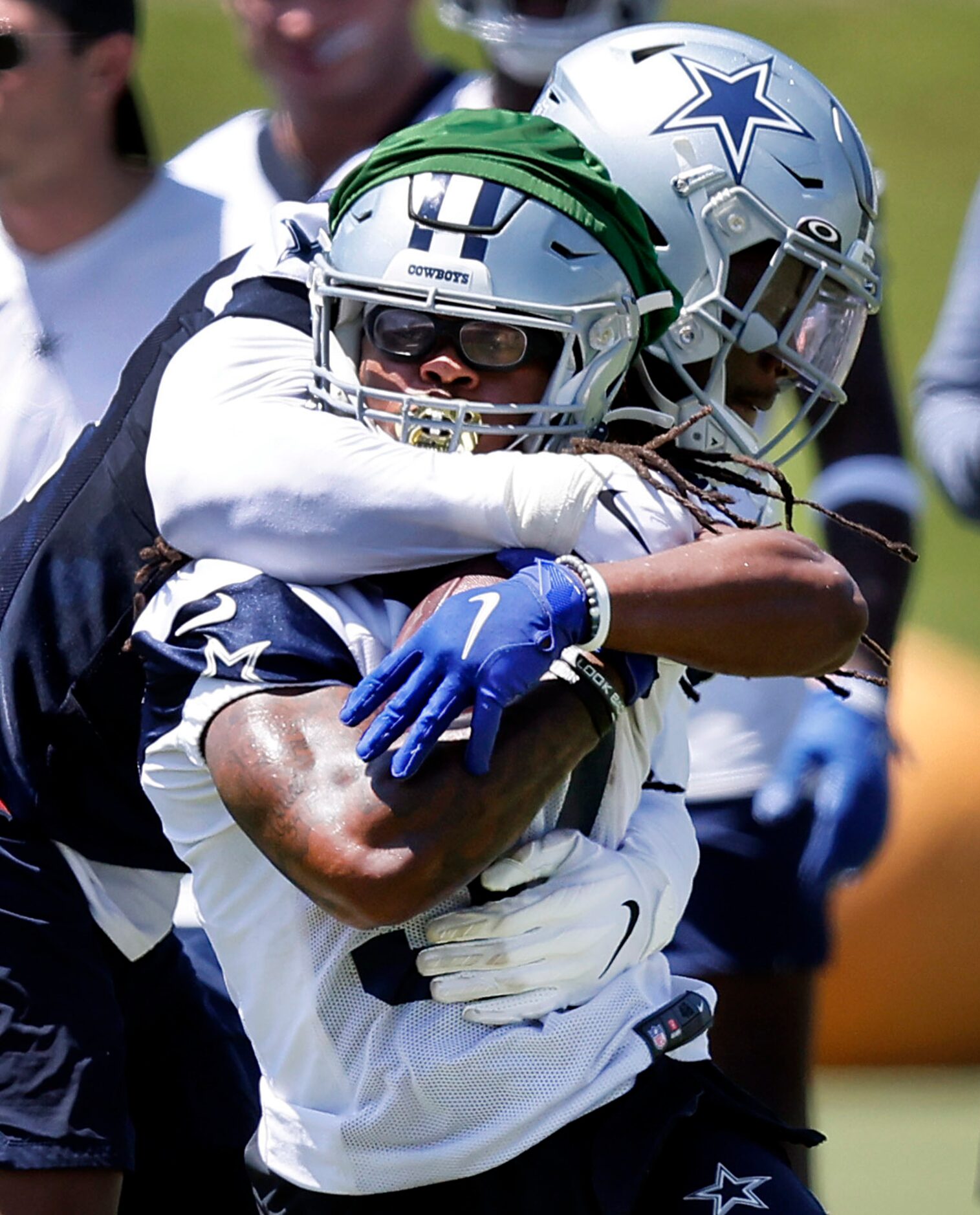 Dallas Cowboys defensive end Randy Gregory (94) collars running back JaQuan Hardy (37) as he...