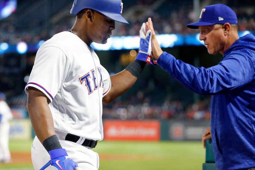 Texas Rangers third baseman Adrian Beltre (29) receives a high five from manager Jeff...