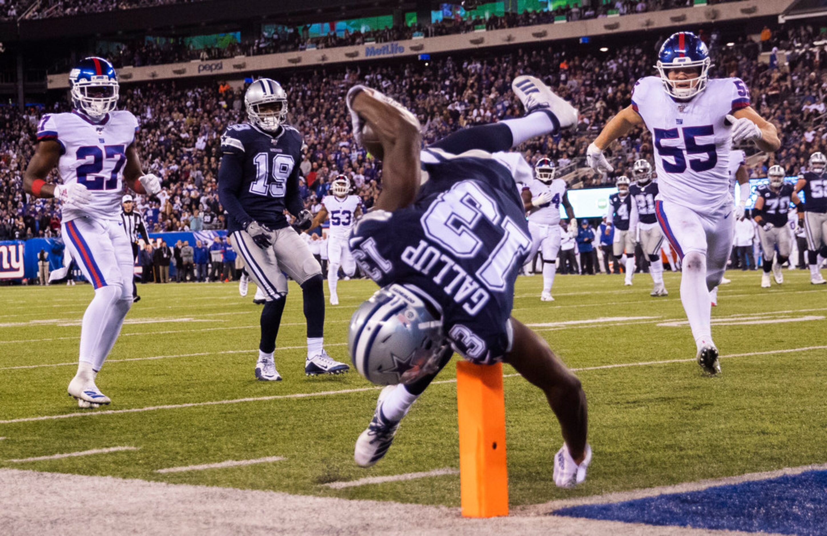 Dallas Cowboys wide receiver Michael Gallup (13) falls across the goal line for a touchdown...