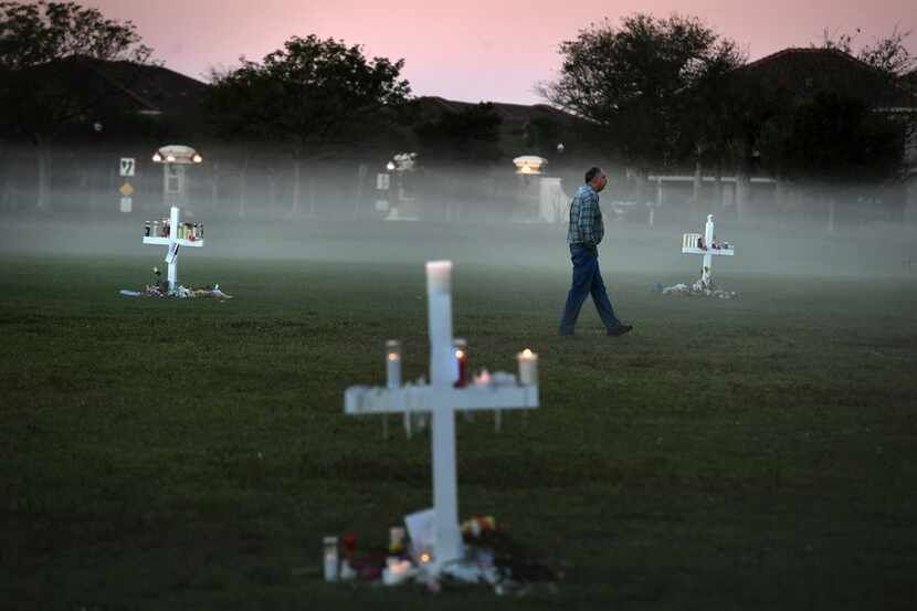 Steve Zipper visits a makeshift memorial in Pine Trails Park for the victims of the...