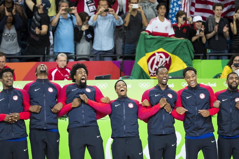 Members of Team USA take the awards stand after their win over Serbia in the men's gold...