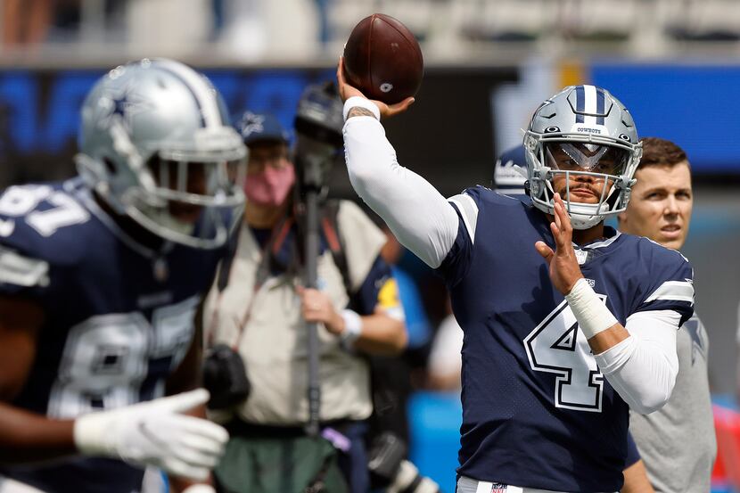 Dallas Cowboys quarterback Dak Prescott (4) throws during pregame warmups before their game...