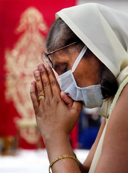 Kiran Ardeshna of McKinney prays during Bhoomi Poojan, a three-day ceremony of praying,...