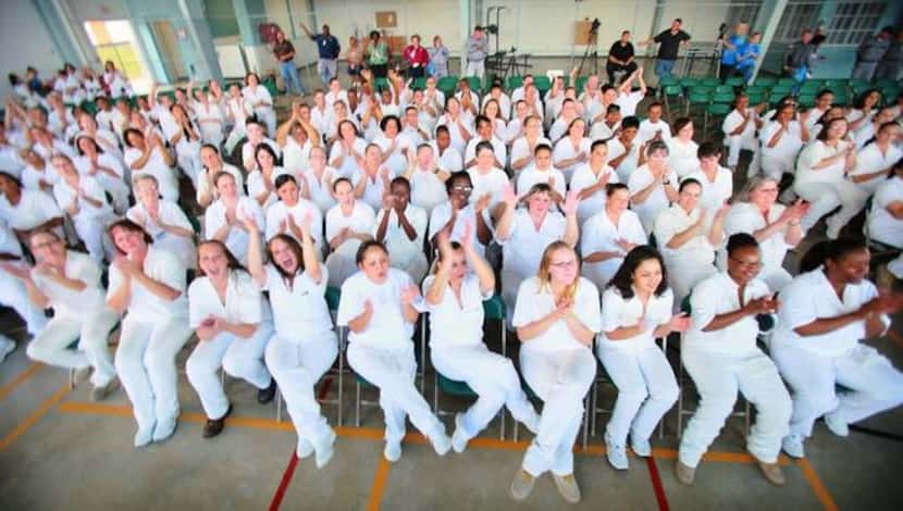 
Women inmates at the Christina Melton Crain Unit cheer after a performance by The...