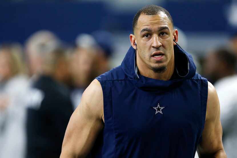 Dallas Cowboys defensive tackle Tyrone Crawford (98) runs the field before a game against...