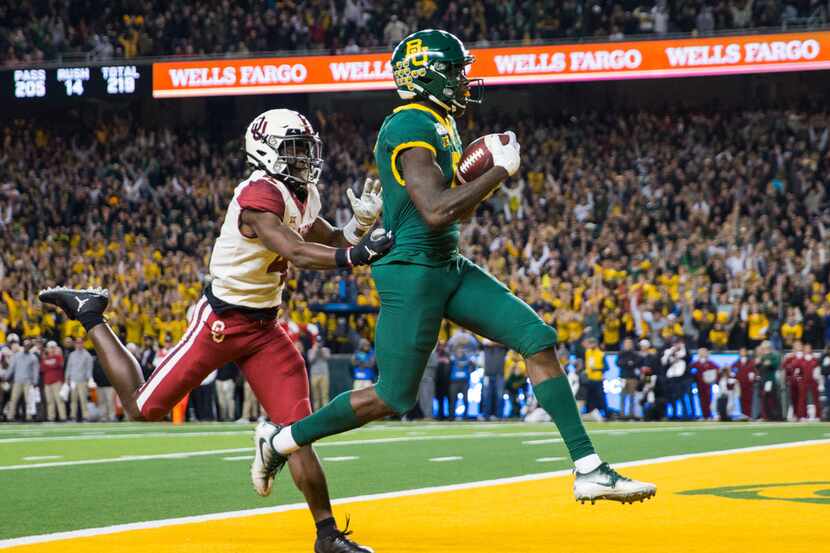 FILE - Baylor wide receiver Denzel Mims (5) runs to the end zone for a touchdown ahead of...