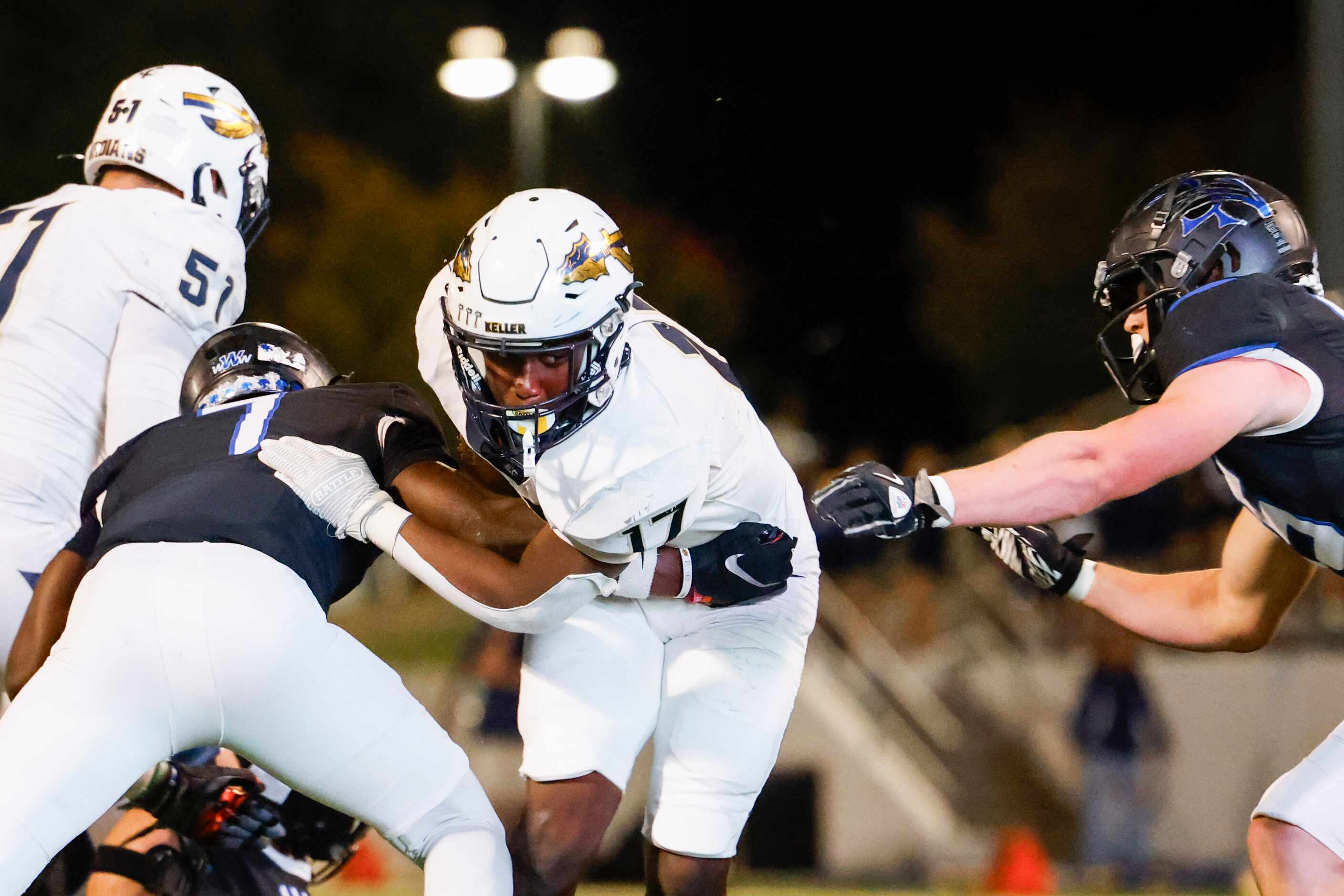 Byron Nelson’s David Kabongo (left) and Justin McCauley (right) tackles Keller High’s Kaleb...