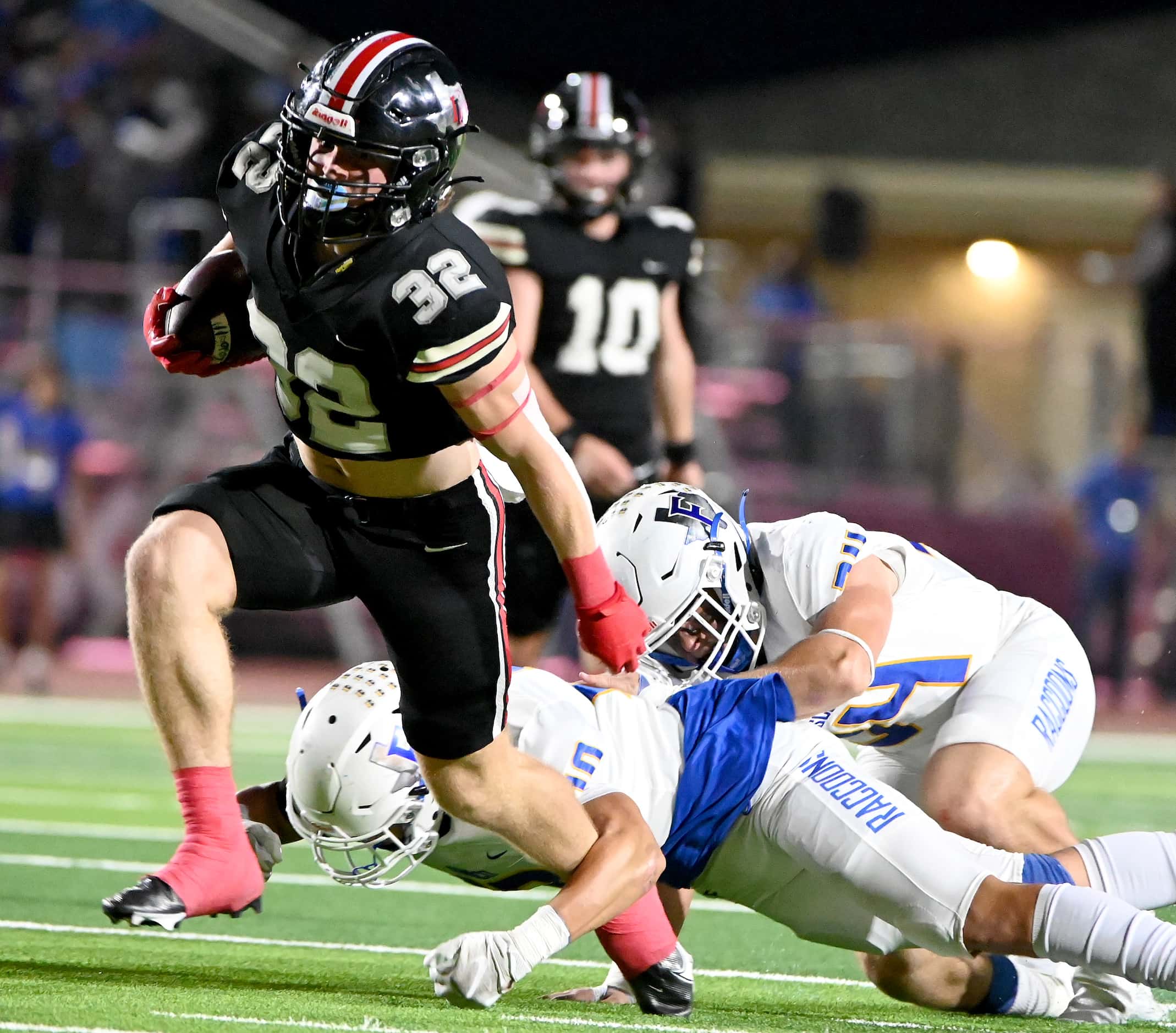 Lovejoy's running back Matthew Mainord (32) runs through tackle attempt’s by Frisco's Tate...